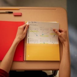 Student pulling papers out of a folder